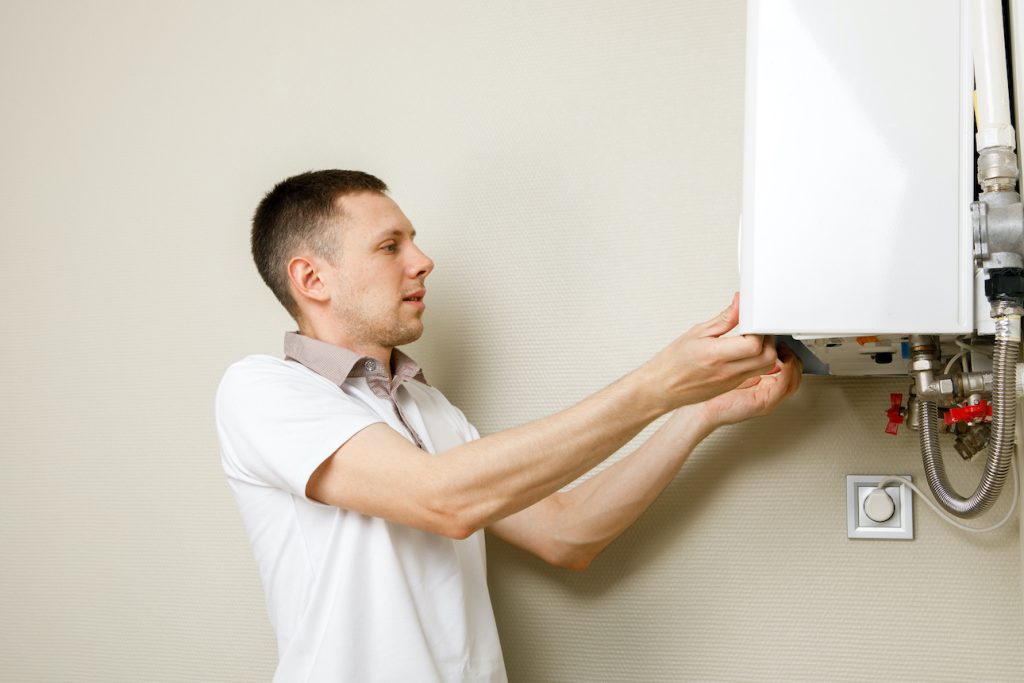 Heating engineer installs new boiler