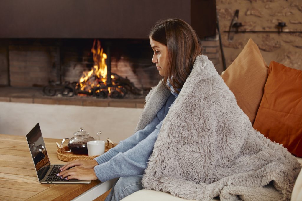 Young woman keeping warm with extra layers
